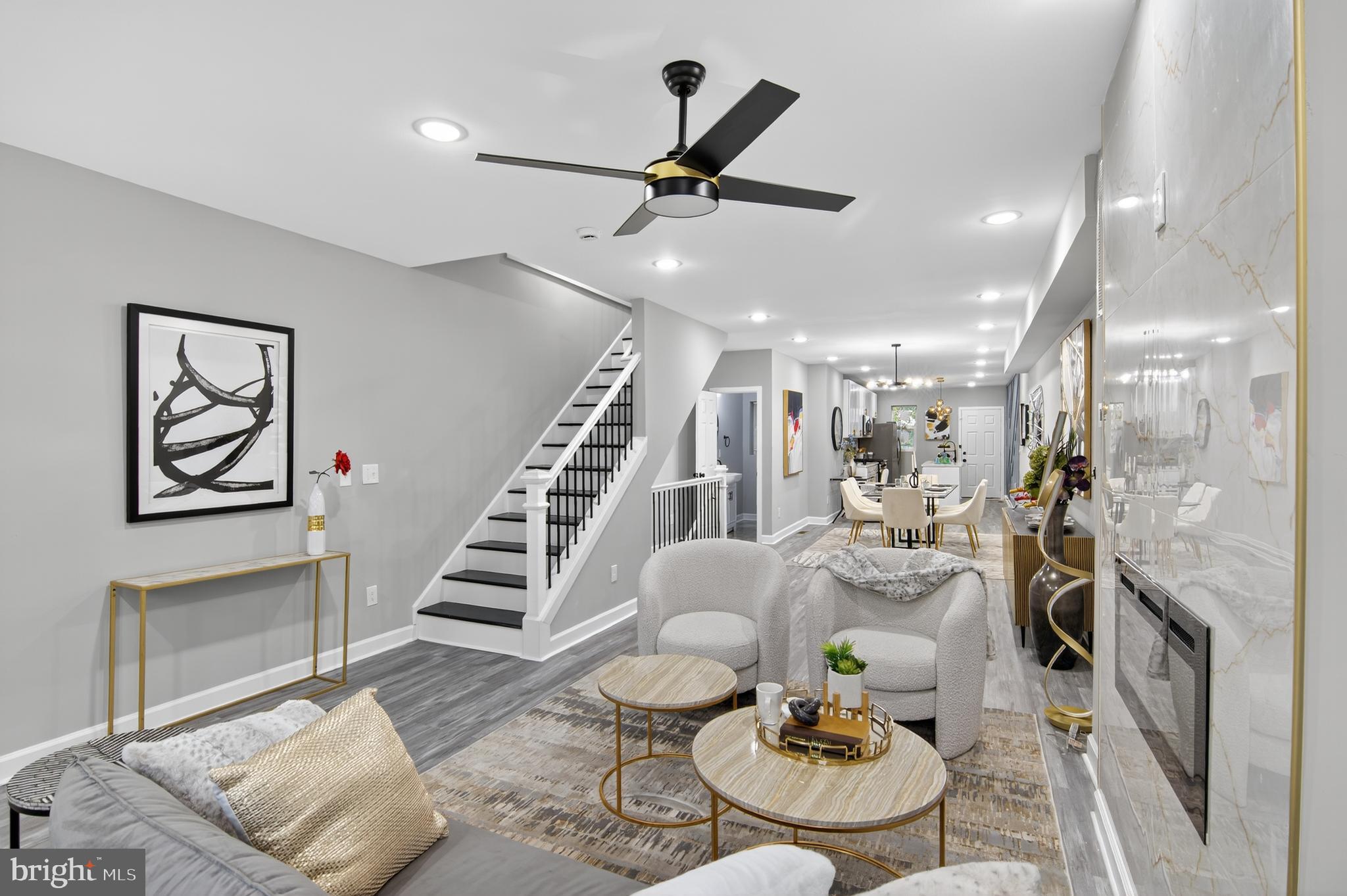 a living room with furniture and kitchen view