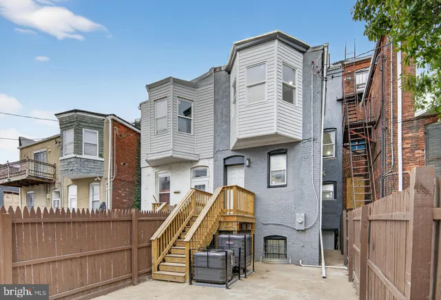 a front view of a house with many windows