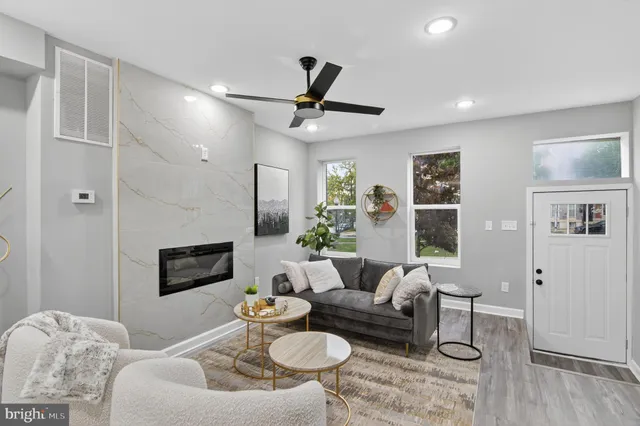 a living room with furniture and a wooden floor