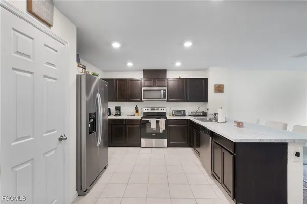 a kitchen with a sink a stove and cabinets