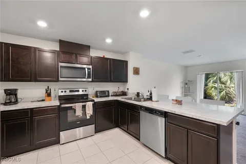 a kitchen with a sink a stove and cabinets