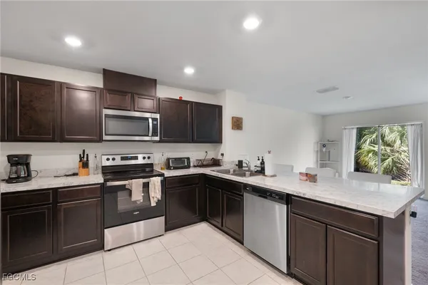 a kitchen with stainless steel appliances a stove sink microwave and cabinets