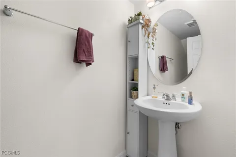 a bathroom with a sink and mirror