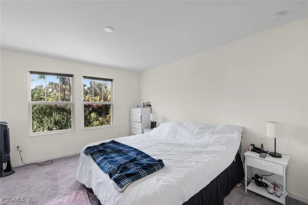 a bedroom with a bed and a flat screen television