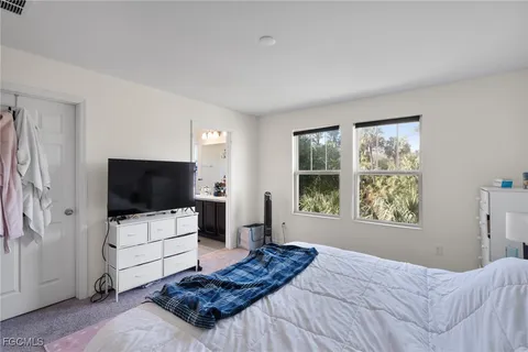 a bedroom with a bed and a flat screen television