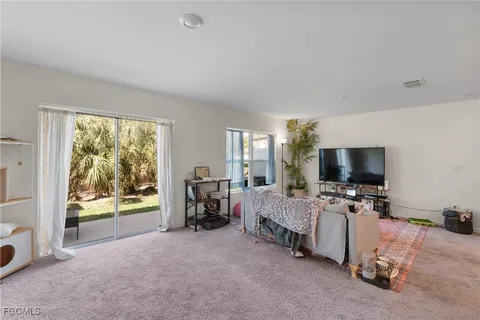 a bedroom with furniture and a flat screen tv
