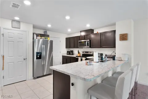 a kitchen with refrigerator and microwave