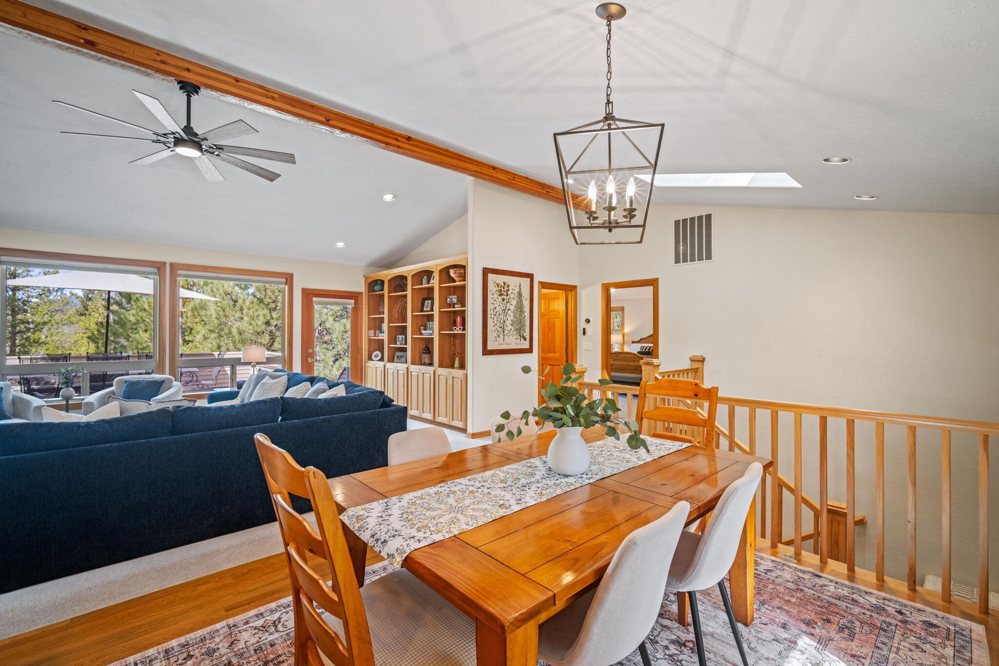 17948 Shadow Lane, Unit 7 Sunriver, OR 97707 - Photo 34 of 92 a dining room with wooden floor a chandelier a wooden table and chairs