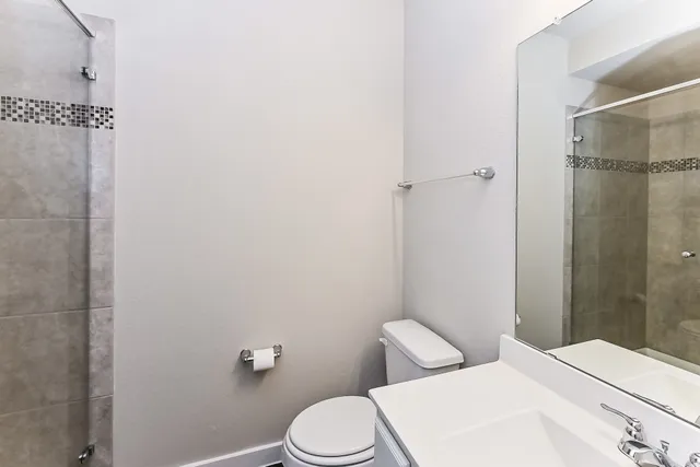 a white toilet sitting next to a bathroom sink