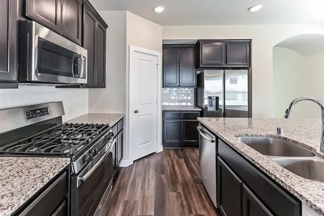 a kitchen that has a sink and a stove
