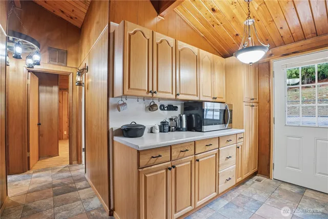 a kitchen with white cabinets and sink