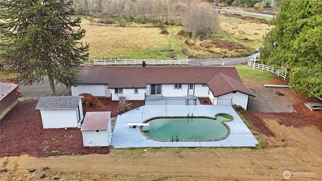 an aerial view of a house with a yard and lake view