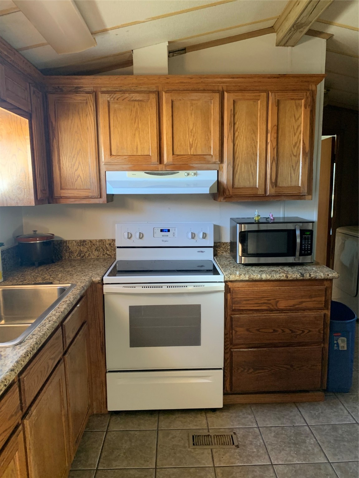 911 15th Street Port O'Connor, TX 77982 - Photo 11 of 22 a kitchen with a stove sink and cabinets