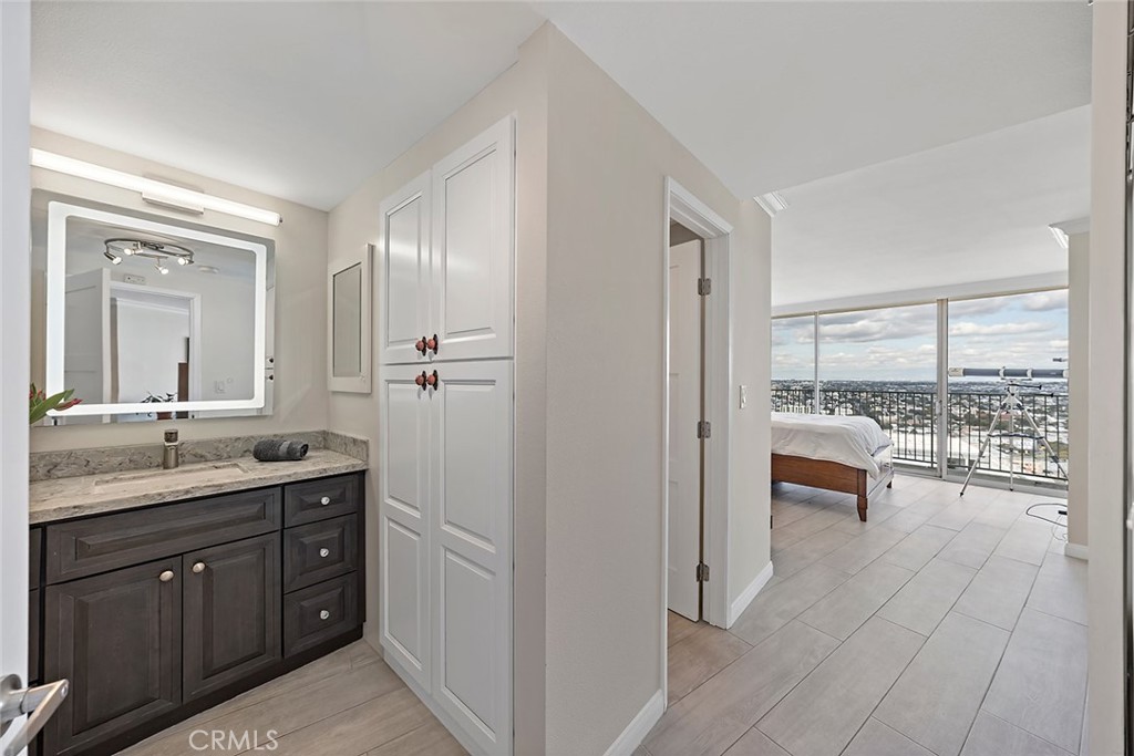 700 East Ocean Boulevard, Unit 3003 Long Beach, CA 90802 - Photo 12 of 39 a spacious bathroom with a granite countertop sink a mirror and a shower