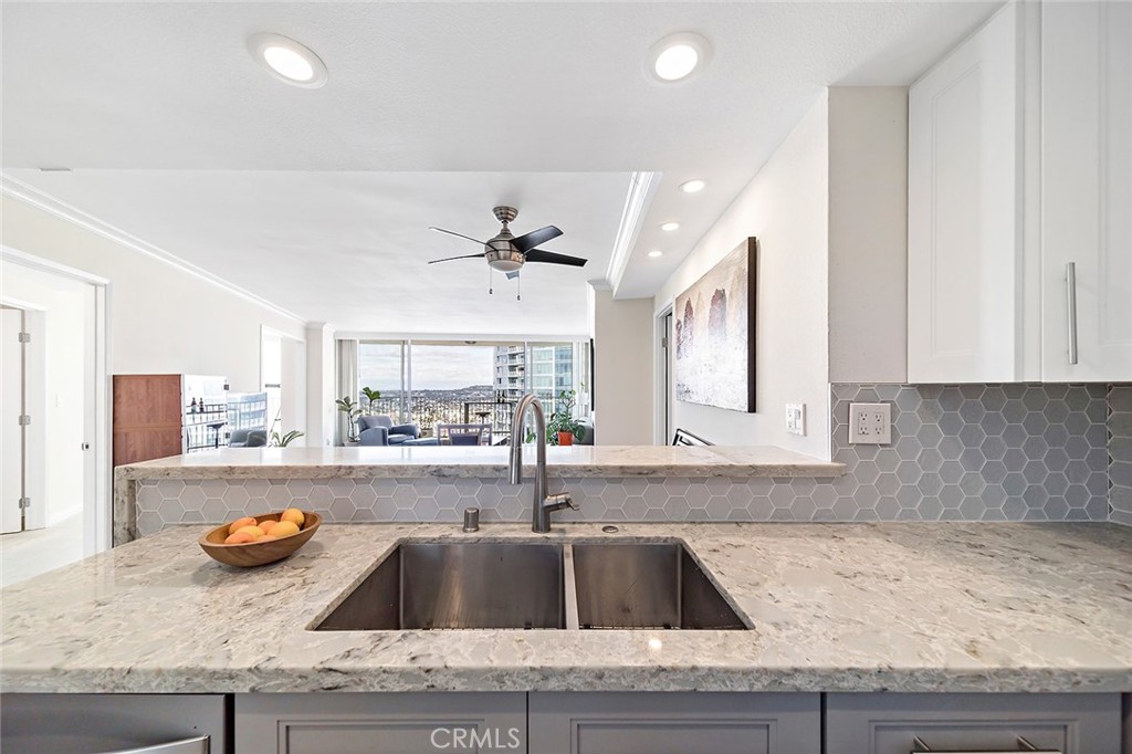 700 East Ocean Boulevard, Unit 3003 Long Beach, CA 90802 - Photo 17 of 39 a kitchen with granite countertop a sink and a stove top oven