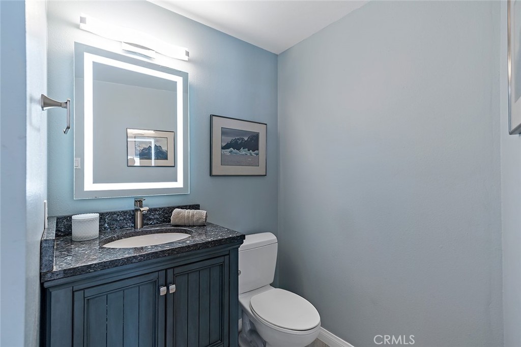 700 East Ocean Boulevard, Unit 3003 Long Beach, CA 90802 - Photo 19 of 39 a bathroom with a granite countertop toilet sink and mirror