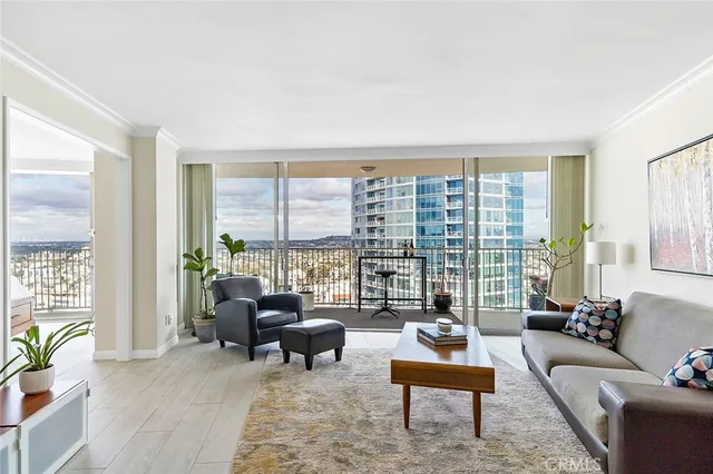 a living room with furniture and a floor to ceiling window