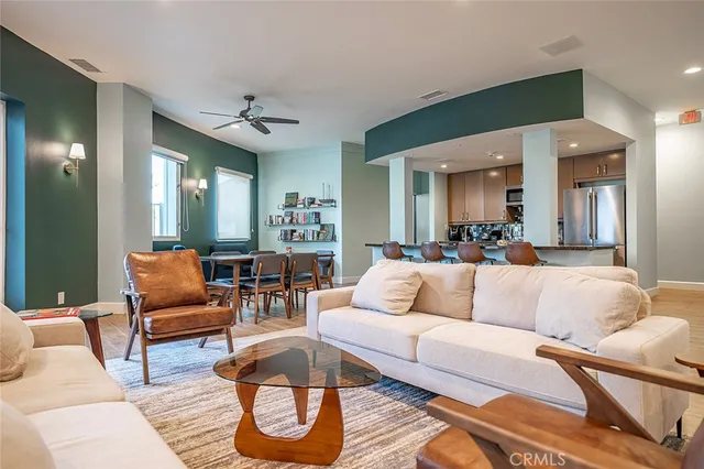 a living room with furniture and a floor to ceiling window
