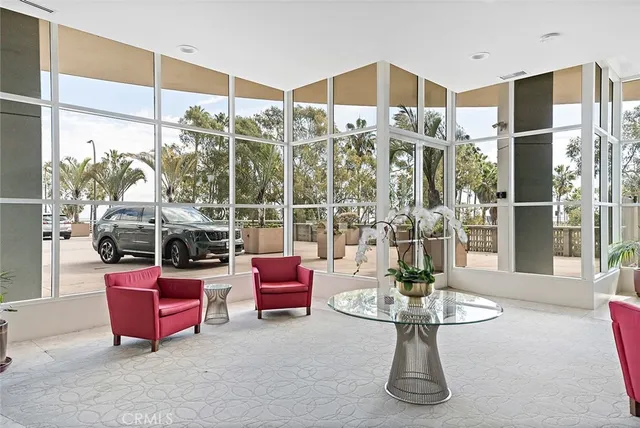 a living room with furniture large window and a table
