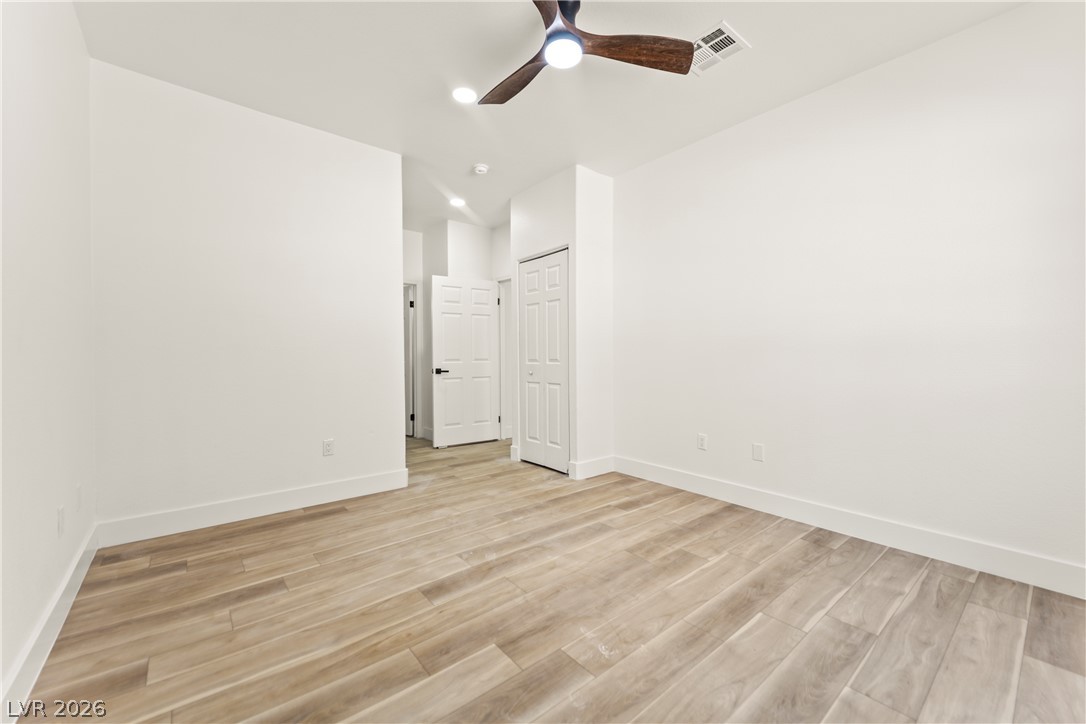 4730 East Craig Road, Unit 1053 Las Vegas, NV 89115 - Photo 13 of 32 Step into this spacious room featuring elegant wood flooring and a modern ceiling fan for ultimate comfort.