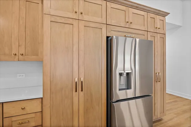 a view of a refrigerator and cabinet