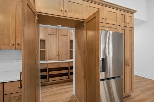 a refrigerator freezer sitting inside of a kitchen
