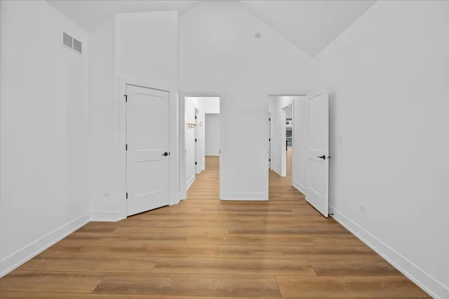 a view of an empty room with wooden floor