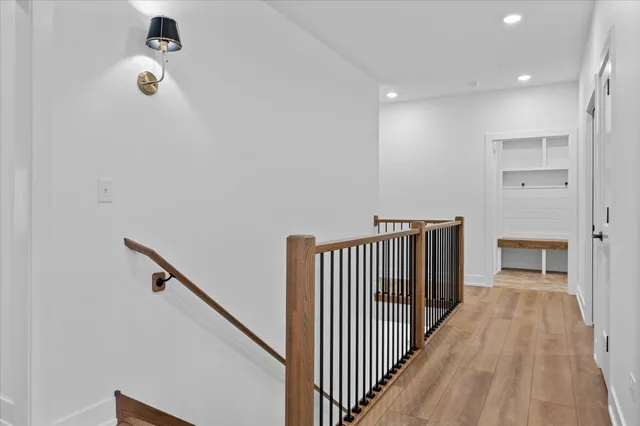 a view of a hallway with wooden floor