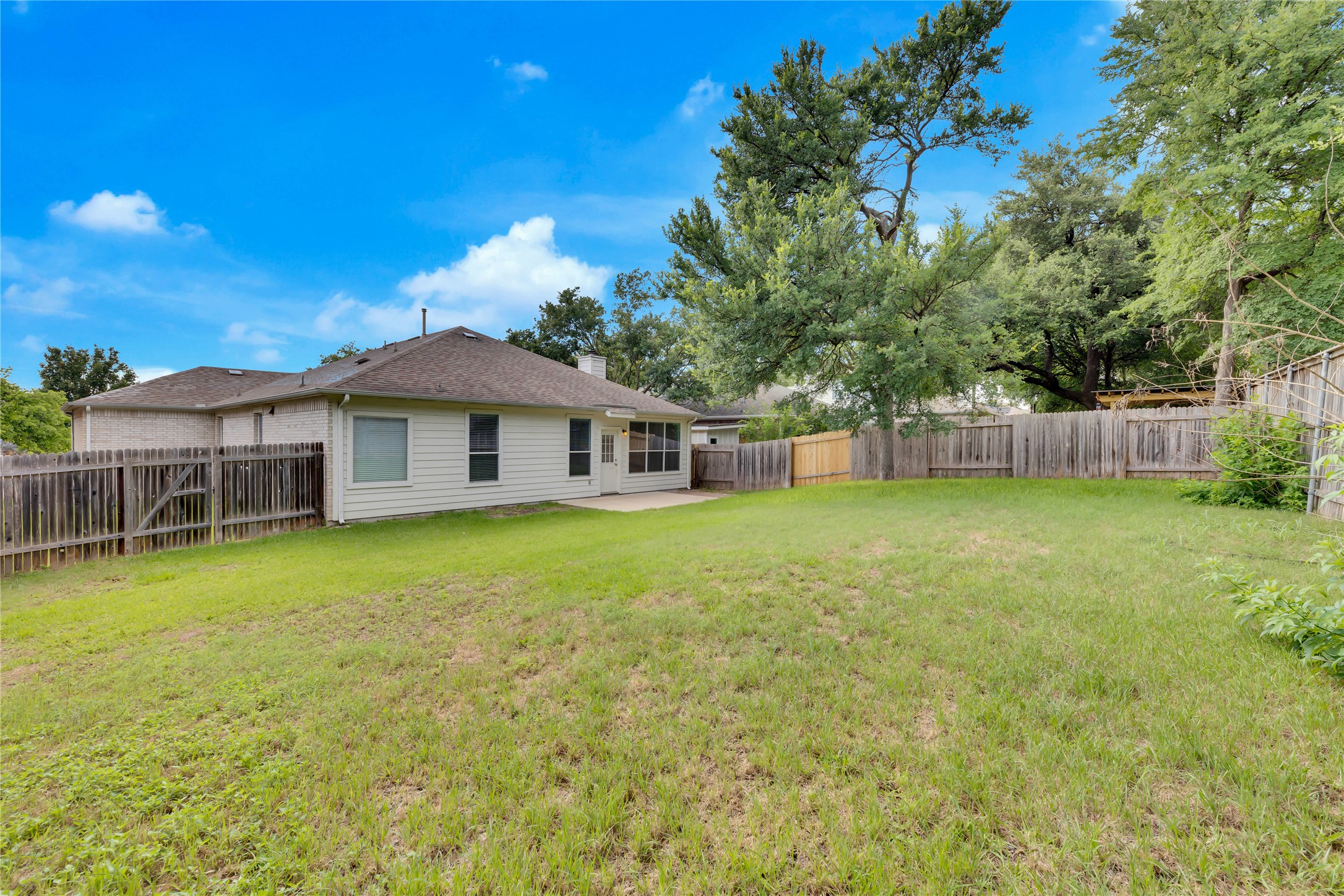 2133 Paradise Ridge Drive Round Rock, TX 78665 - Photo 22 of 22 Expansive grassy yard with wood fencing and mature trees