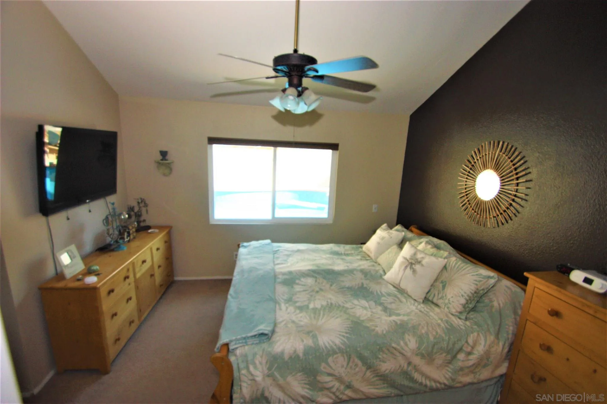 10417 Cadwell Road Santee, CA 92071 - Photo 4 of 12 a bedroom with a bed and a flat tv screen on dresser