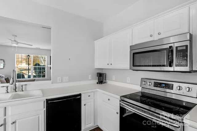 a kitchen with a stove microwave and sink