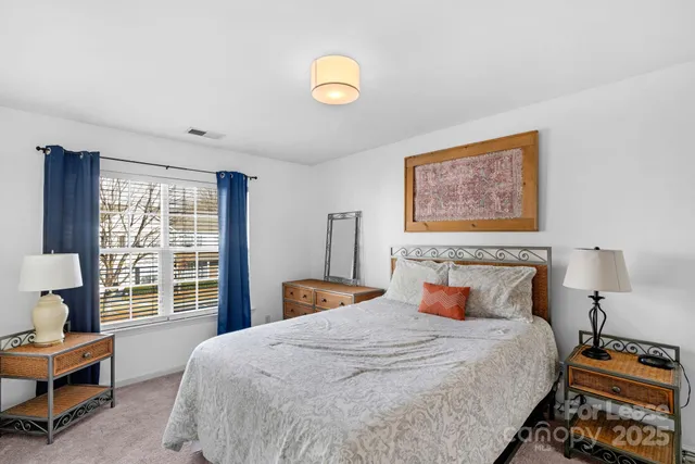 a bedroom with bed and wooden floor
