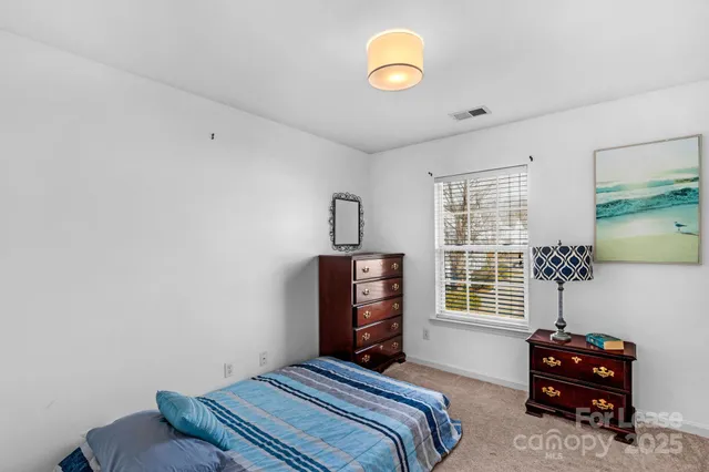 a bedroom with bed and a window