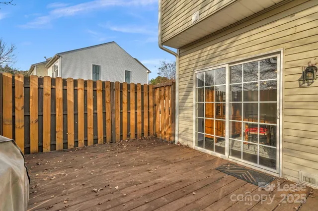 a view of a house with a wooden deck