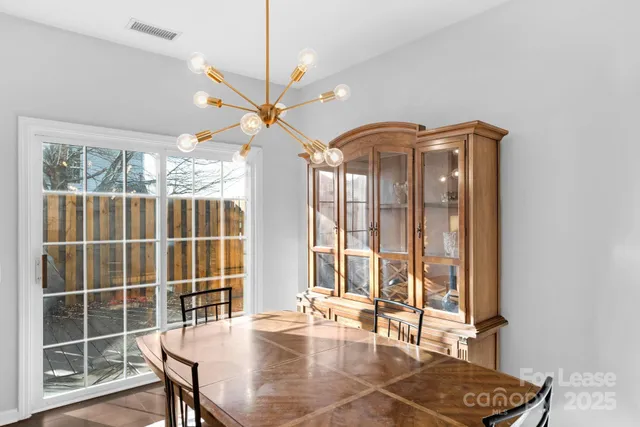 a view of a dining room with furniture and a window
