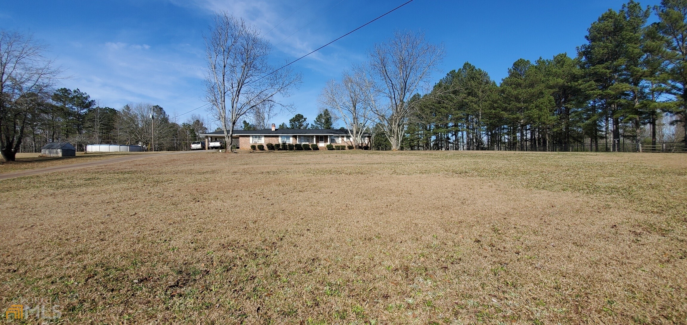 a view of a field with trees in the background