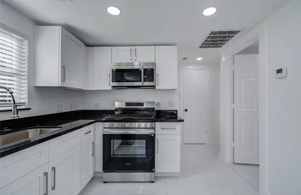 a kitchen with a stove and a microwave