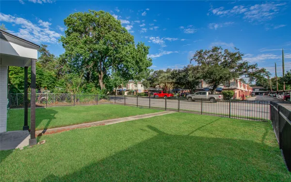 a garden with trees in the background