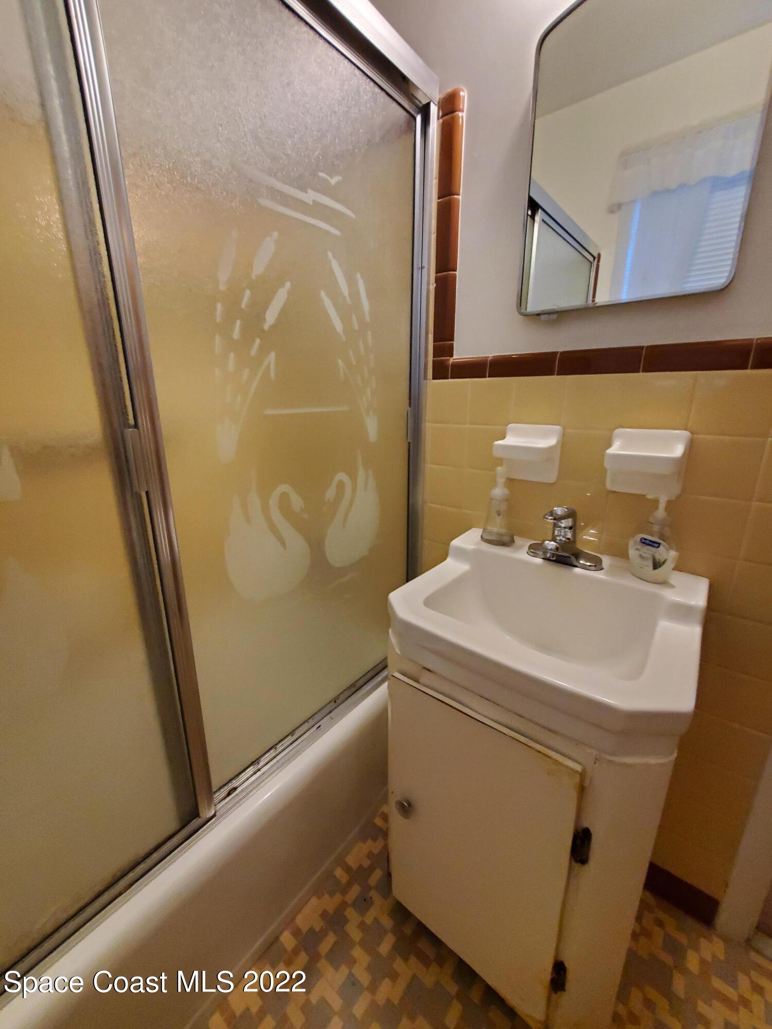 1507 Emory Lane Cocoa, FL 32922 - Photo 35 of 57 a bathroom with a sink and a mirror