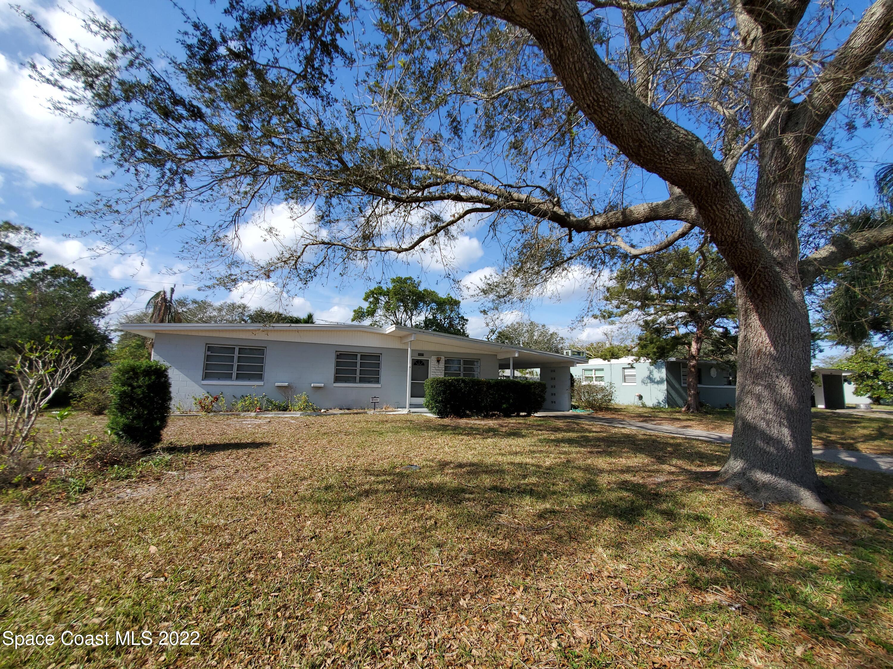1507 Emory Lane Cocoa, FL 32922 - Photo 56 of 57 a view of house with yard and trees in front of it