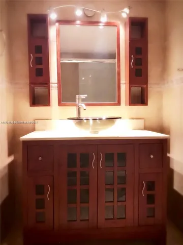 a bathroom with a sink and a mirror