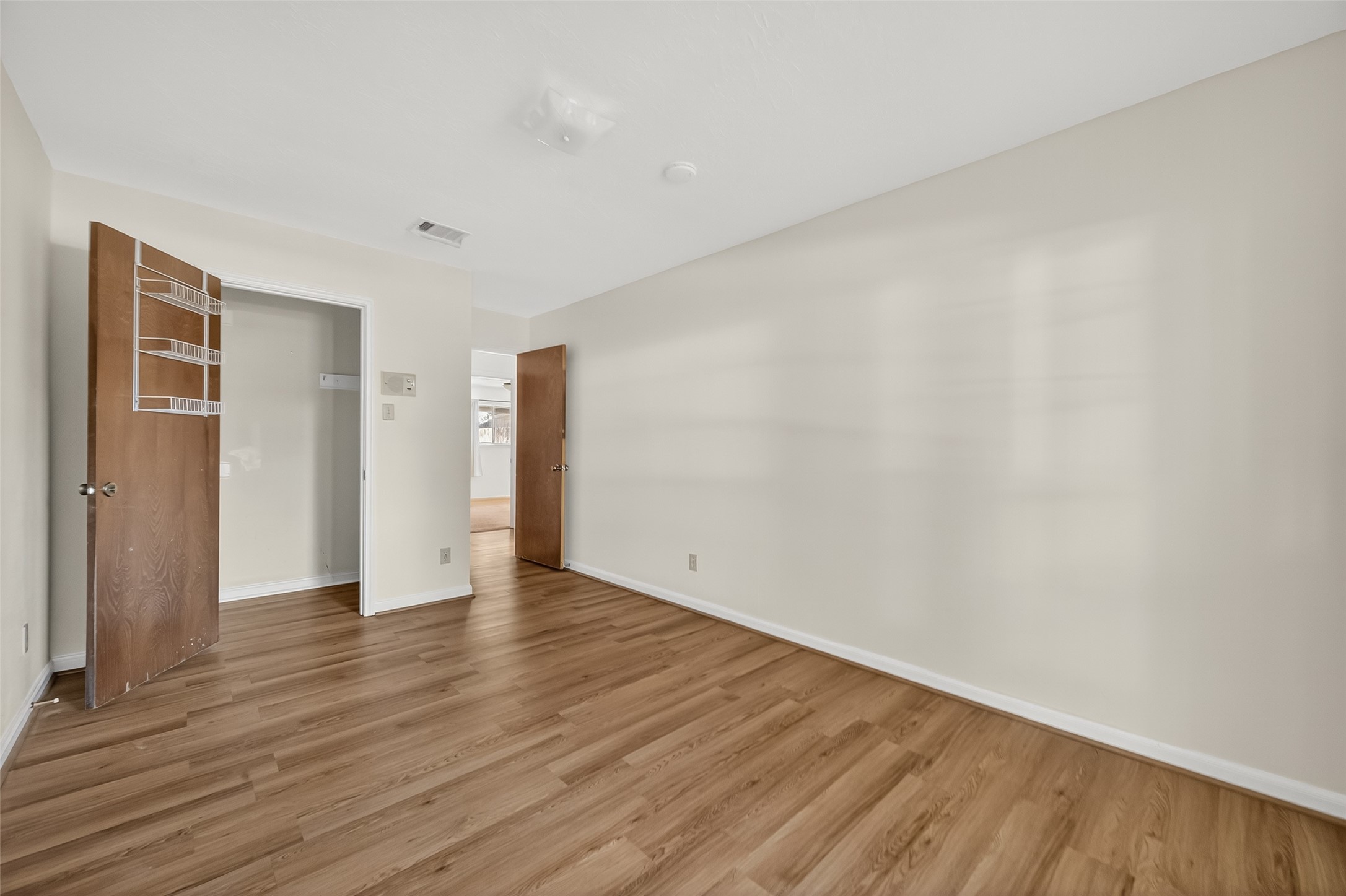 9218 Rowan Lane Houston, TX 77036 - Photo 11 of 32 a view of an empty room with wooden floor