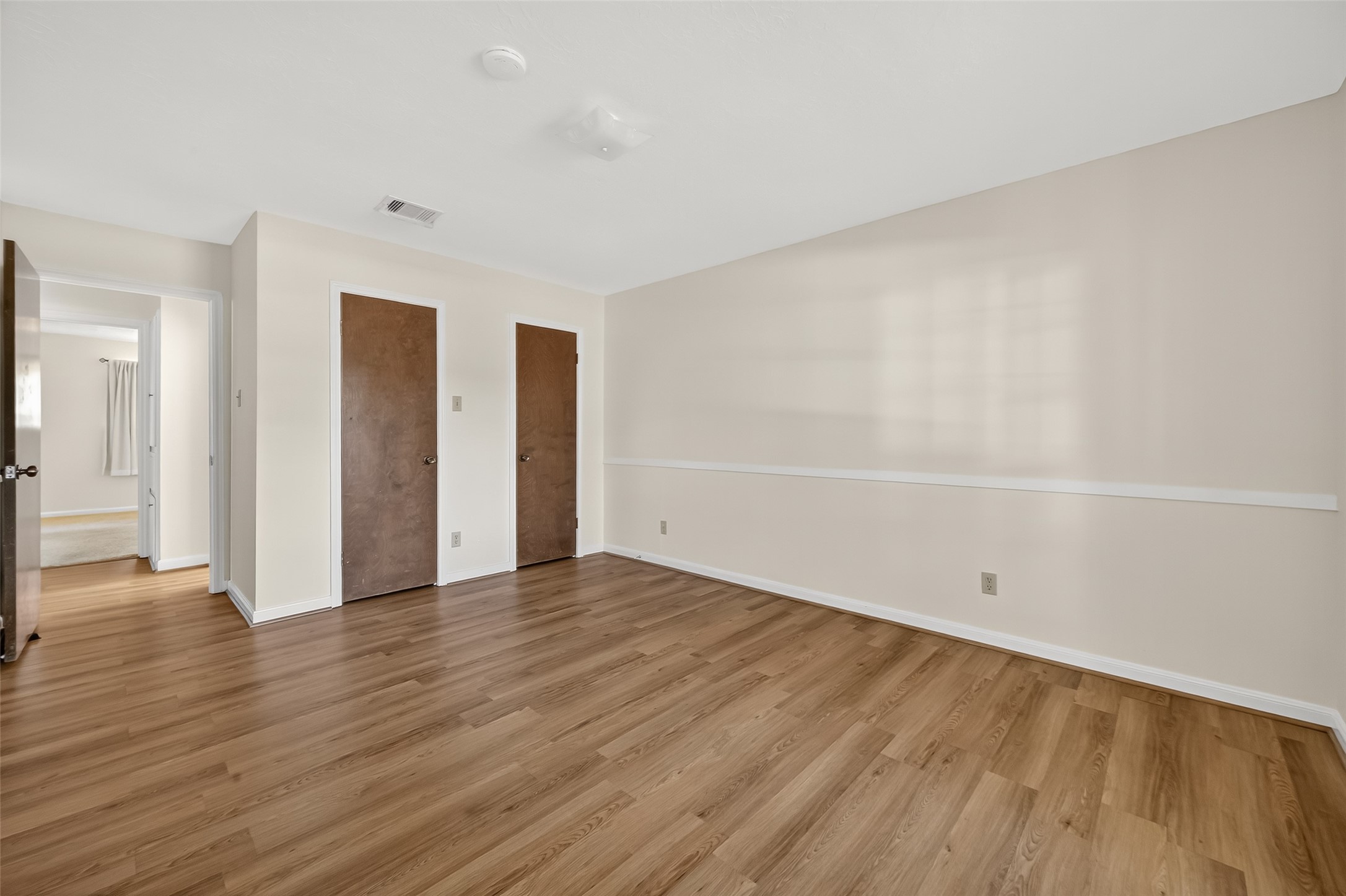 9218 Rowan Lane Houston, TX 77036 - Photo 15 of 32 a view of an empty room with wooden floor