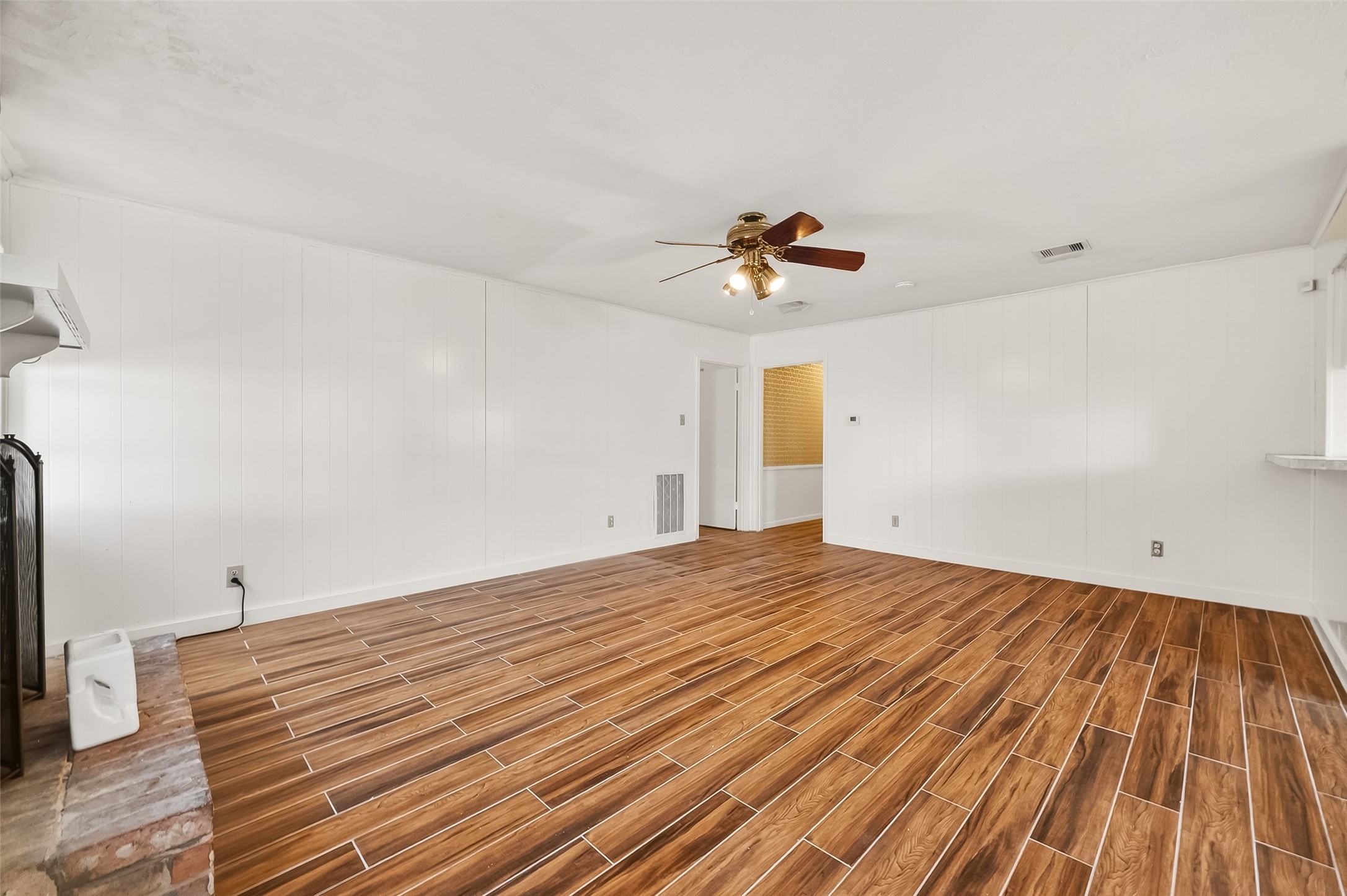 9218 Rowan Lane Houston, TX 77036 - Photo 16 of 32 a view of a room with wooden floor and ceiling fan