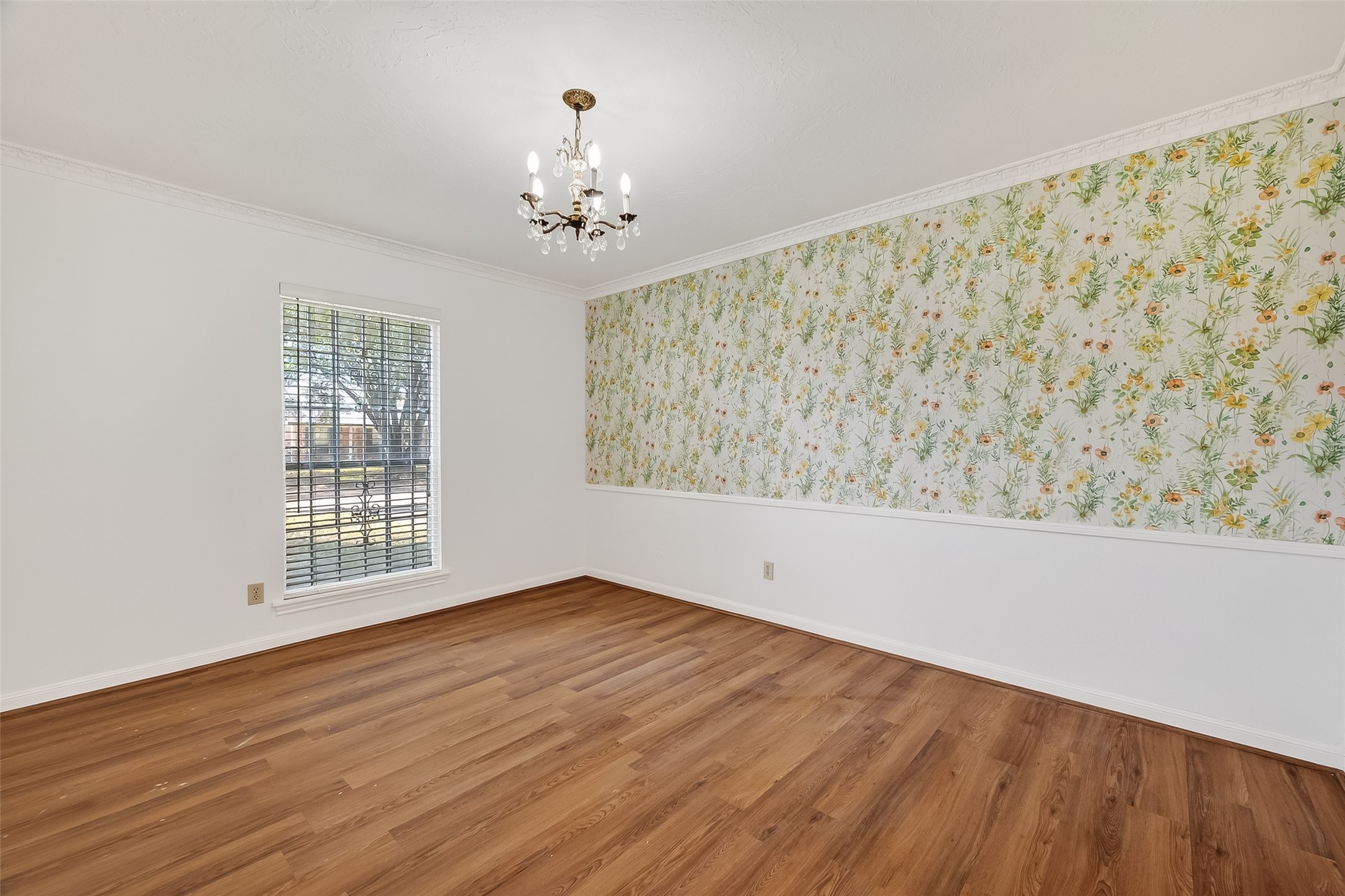 9218 Rowan Lane Houston, TX 77036 - Photo 17 of 32 a view of an empty room with wooden floor and a window