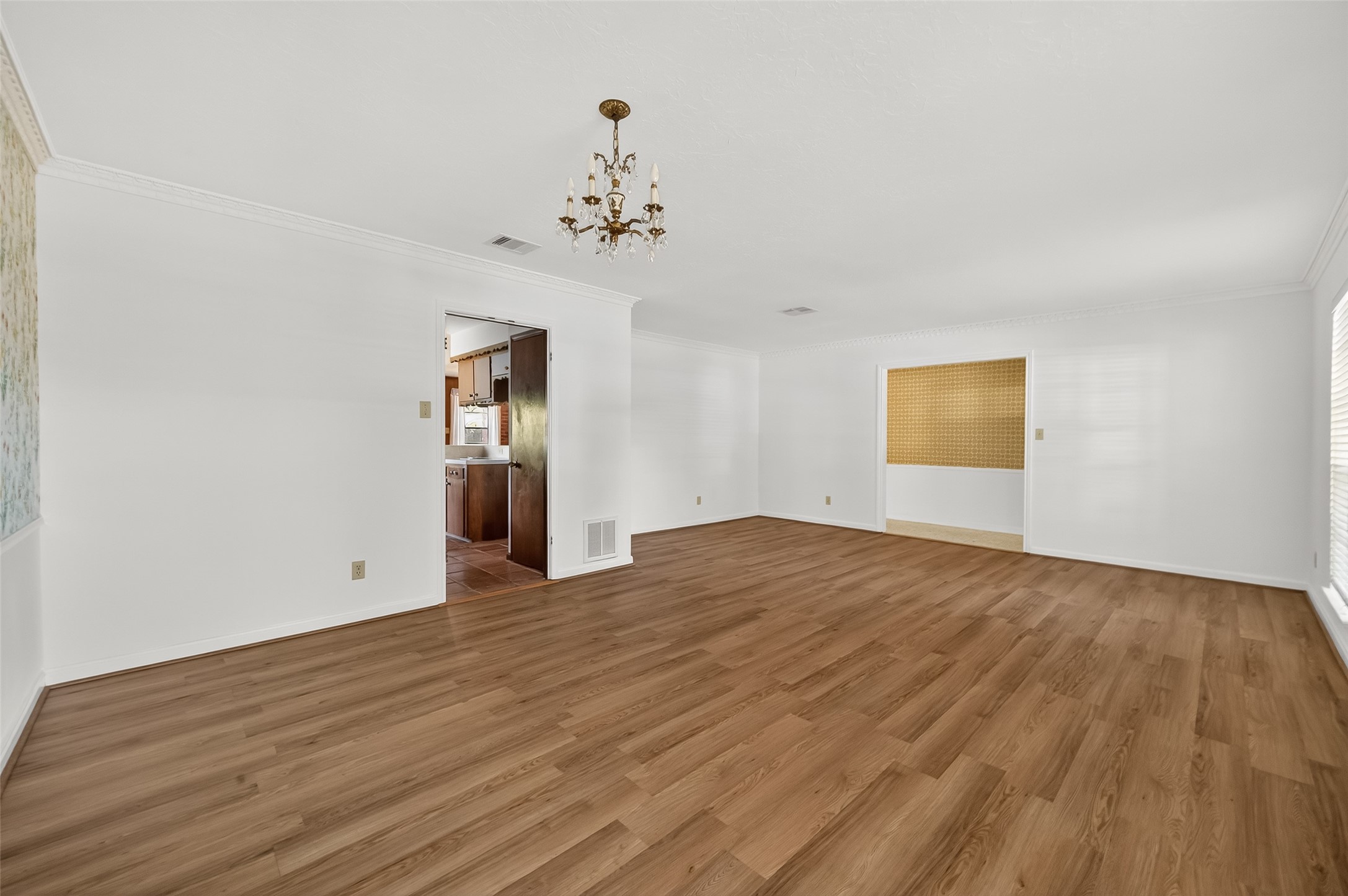 9218 Rowan Lane Houston, TX 77036 - Photo 2 of 32 a view of empty room with wooden floor and ceiling fan