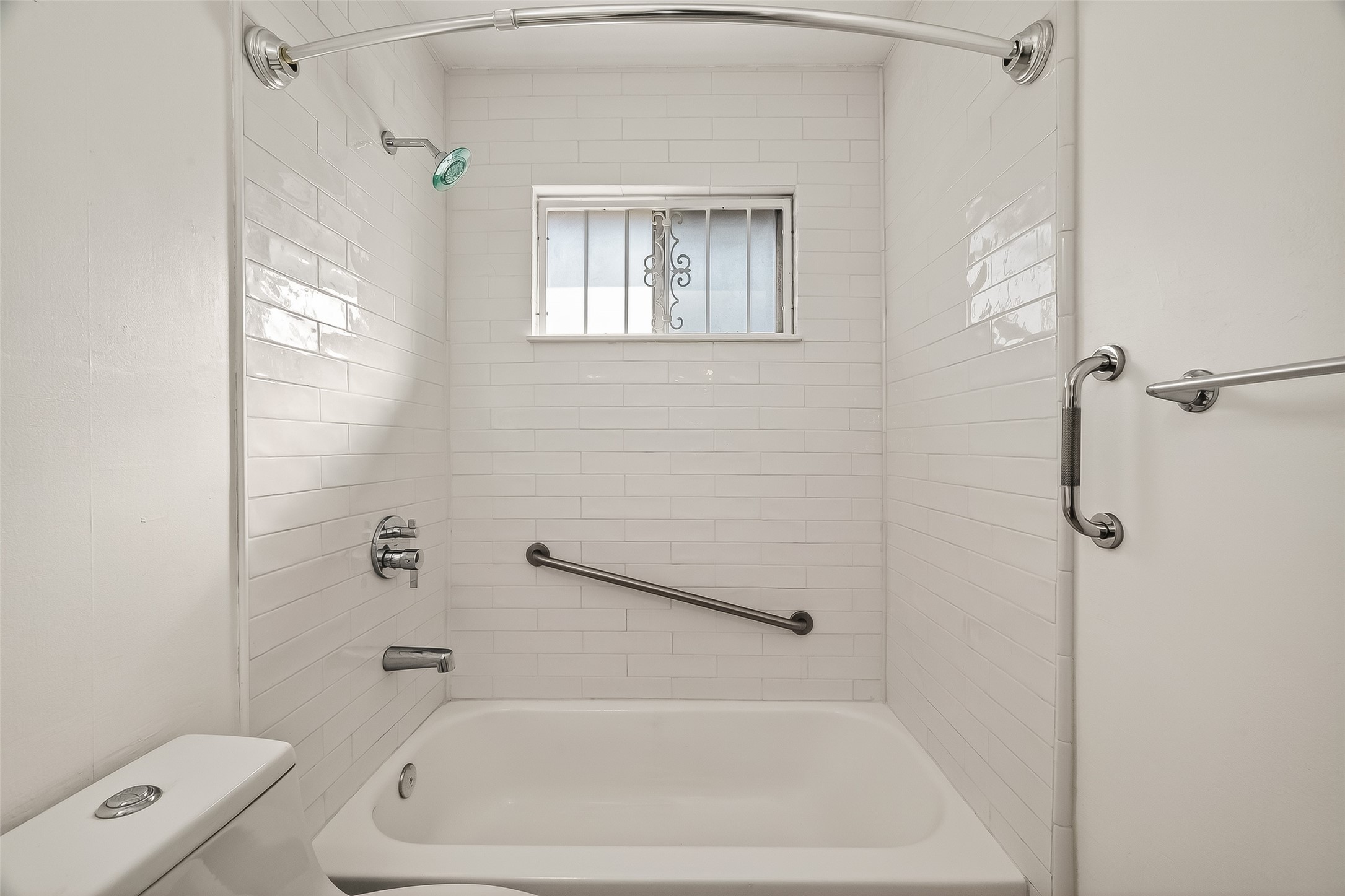 9218 Rowan Lane Houston, TX 77036 - Photo 24 of 32 a bath tub sitting next to a white toilet and a shower