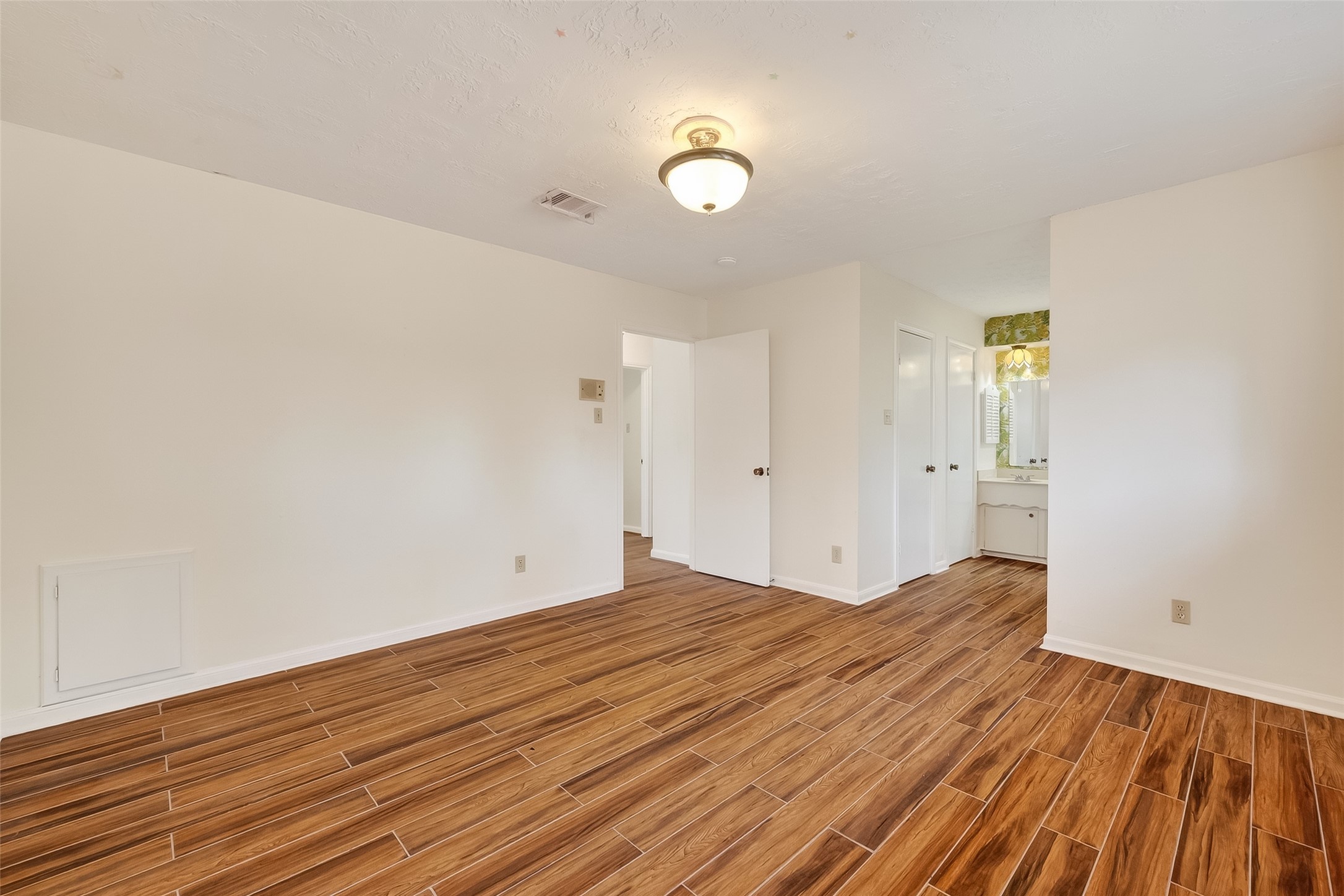 9218 Rowan Lane Houston, TX 77036 - Photo 27 of 32 a view of room with wooden floor and fan