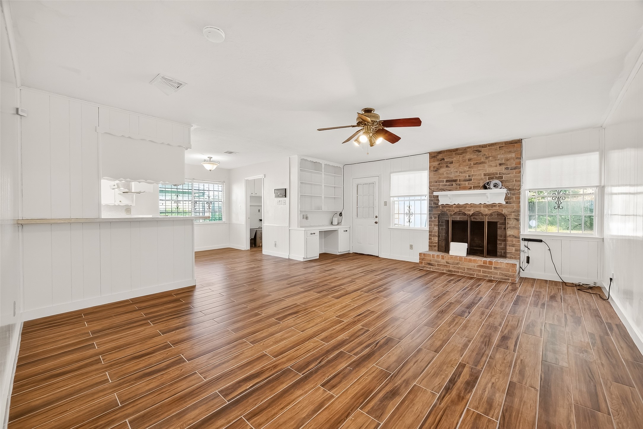 9218 Rowan Lane Houston, TX 77036 - Photo 4 of 32 a view of empty room with wooden floor and fireplace
