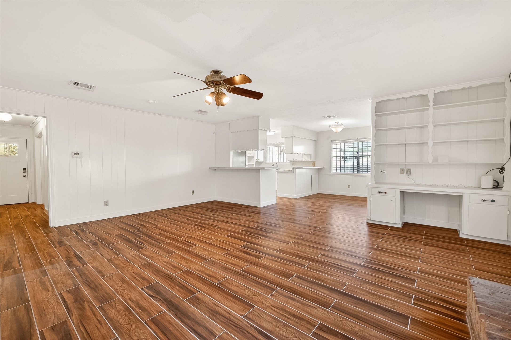 9218 Rowan Lane Houston, TX 77036 - Photo 5 of 32 a view of empty room with wooden floor and kitchen